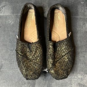 Tom’s Black and Gold Metallic Shoes